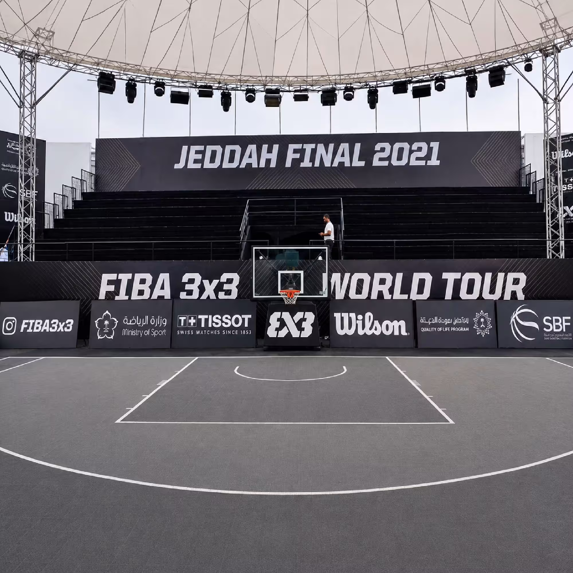 Temporary outdoor grandstand and sports event seating with lighting truss at a basketball court