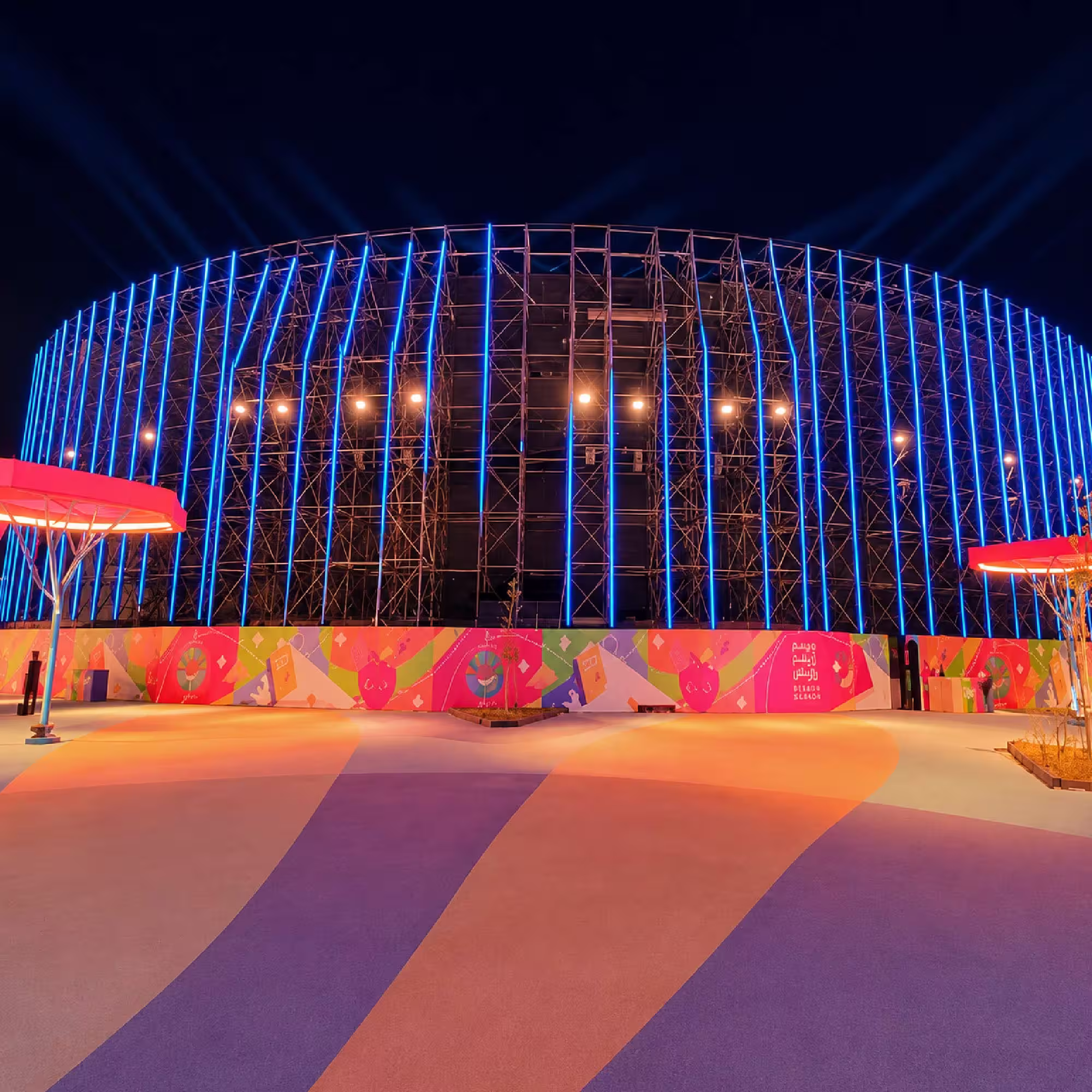 Large illuminated scaffolding structure for an outdoor event at night